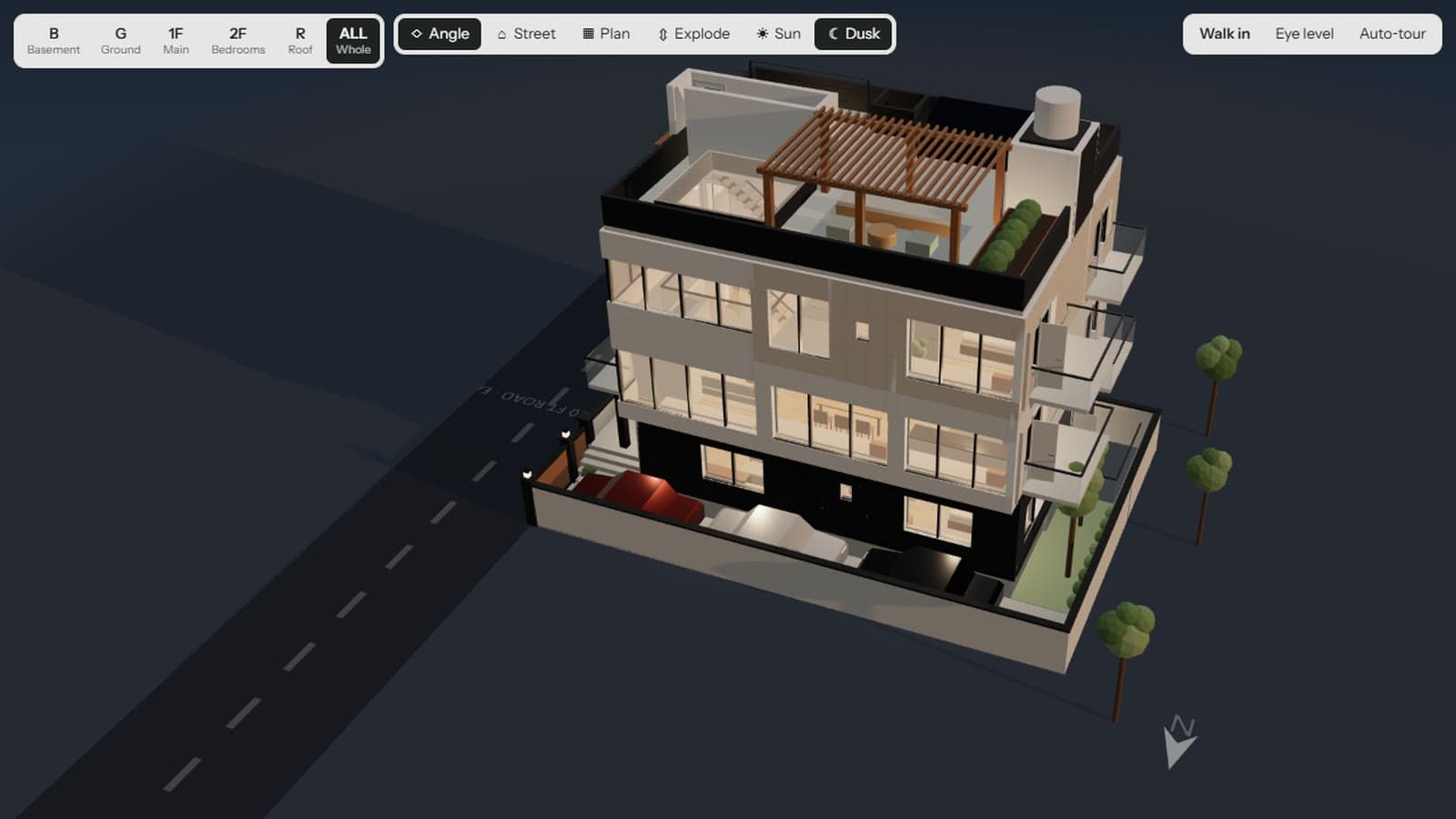 The finished house at dusk from above the corner: four storeys, lit windows, a pergola on the roof terrace and cars in the open drive.